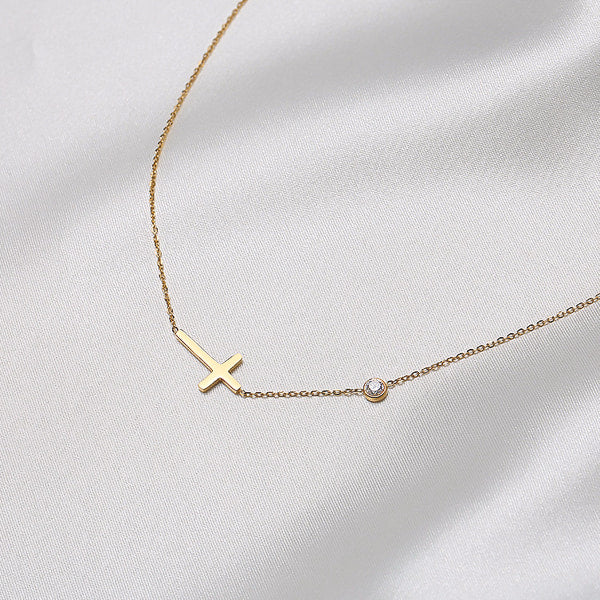 Gold sideways cross necklace details