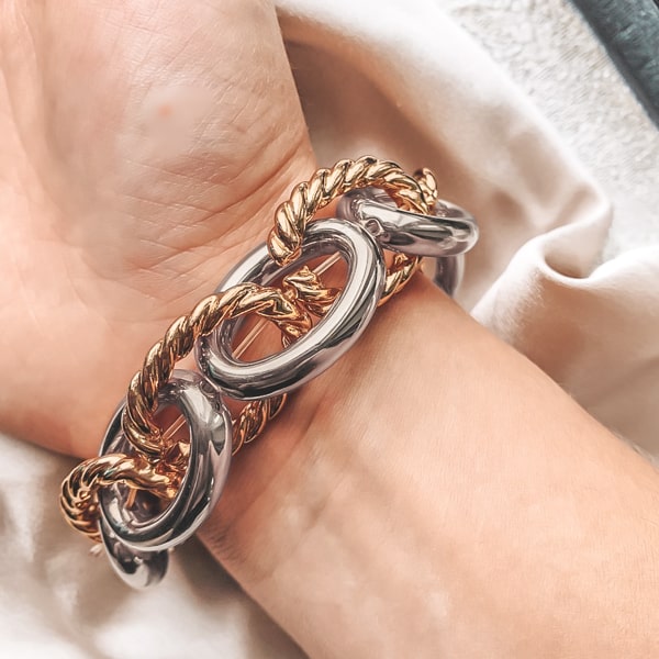 Gold & silver chunky designer bracelet on a woman's wrist