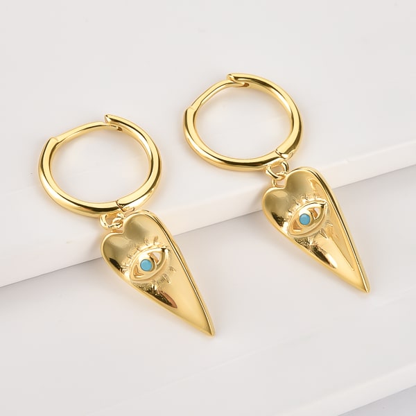 Gold spear of luck huggie hoop earrings detail