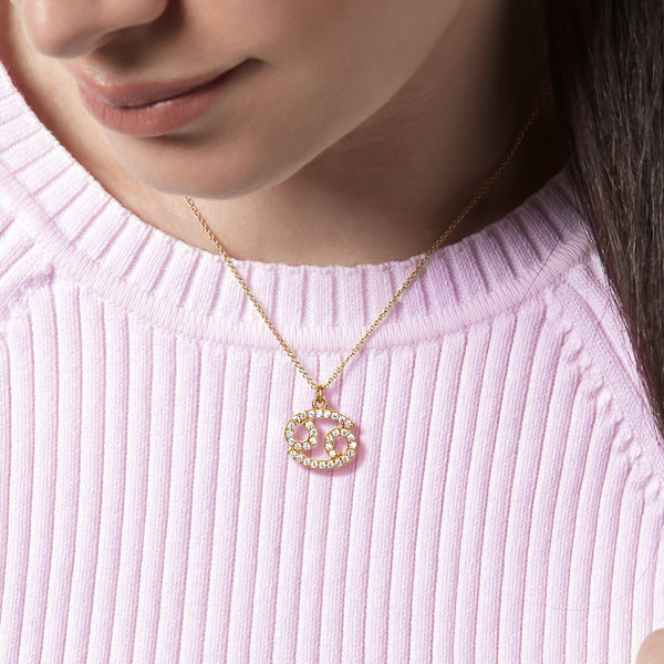 Woman wearing a gold vermeil Cancer necklace