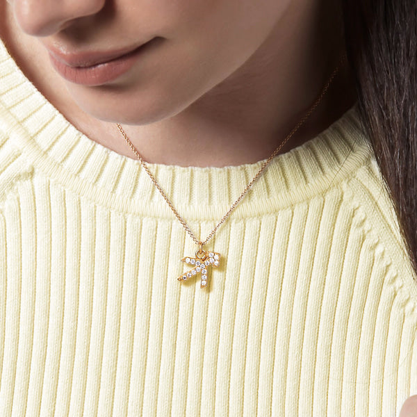 Woman wearing a gold vermeil Sagittarius necklace