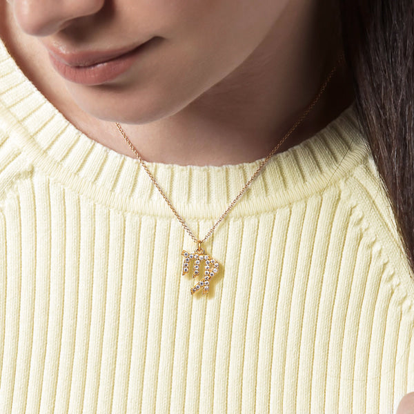Woman wearing a gold vermeil Virgo necklace