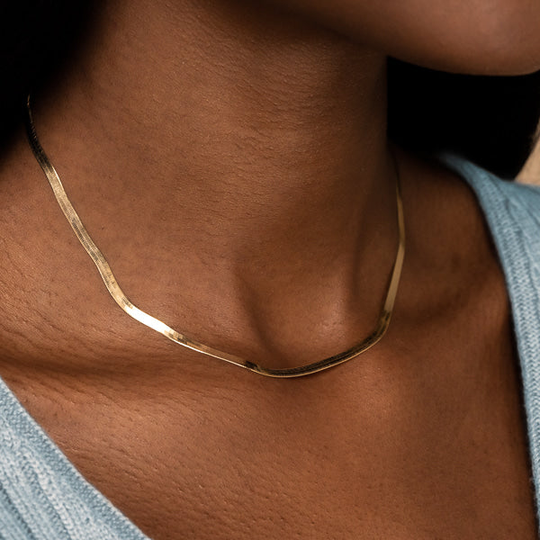Woman wearing gold vermeil herringbone chain necklace