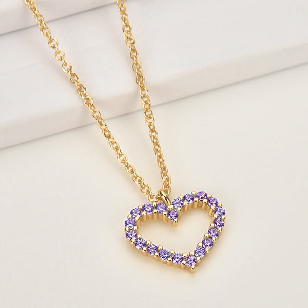 Violet crystal open heart on a gold necklace display