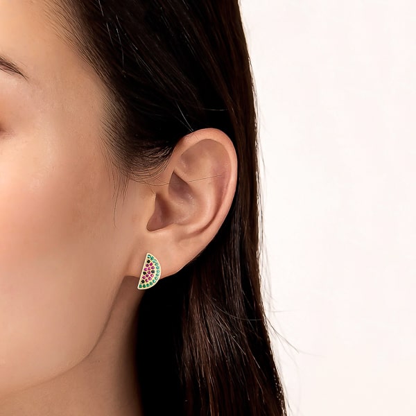 Woman wearing gold watermelon stud earrings