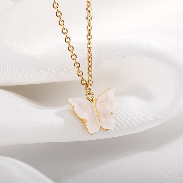 White butterfly on a golden necklace display