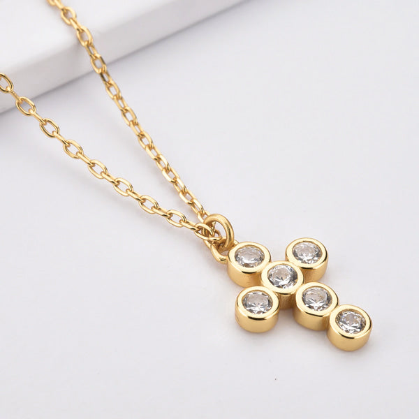  Gold rounded cross necklace with white crystals details