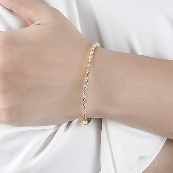 Gold zirconia bangle bracelet on a woman's wrist