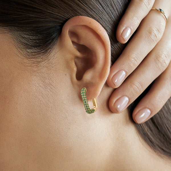 Woman wearing green and gold cubic zirconia pavé square hoop earrings