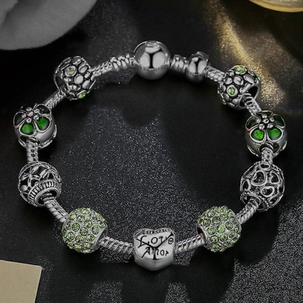 Green charm bracelet with snake chain