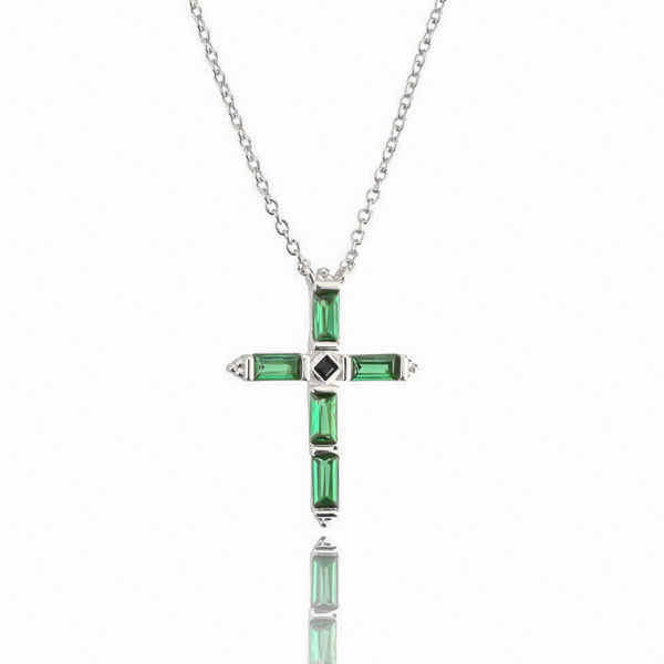 Green crystal cross on a silver necklace display