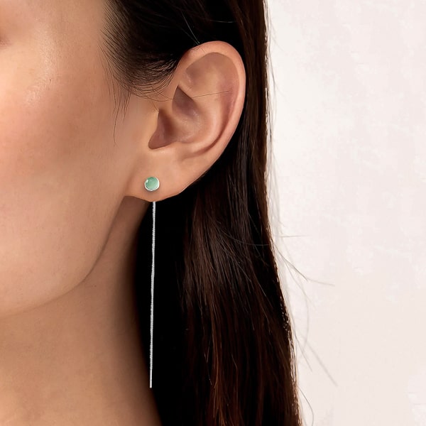 Woman wearing green opal threader earrings