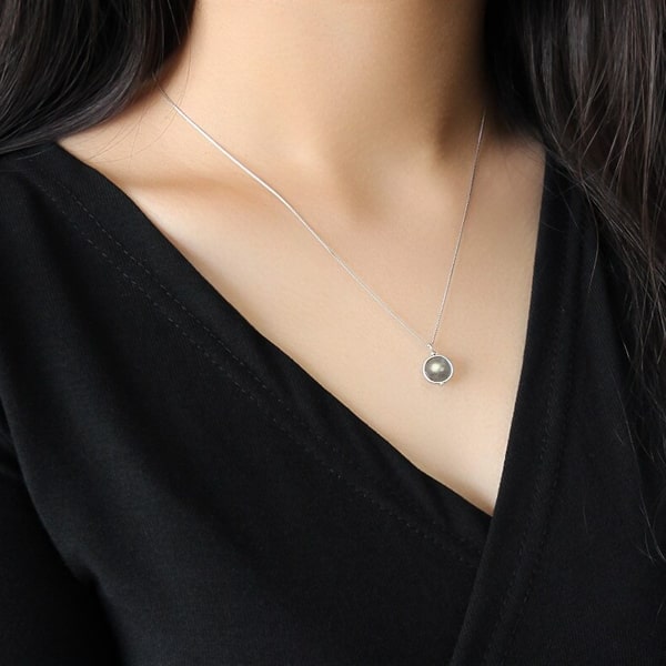 Woman wearing a grey moonstone pendant necklace