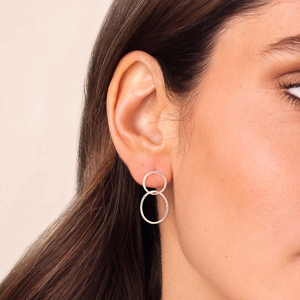 Woman wearing silver circle drop earrings