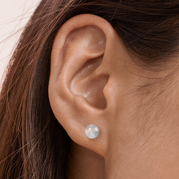 Woman wearing labradorite stud earrings
