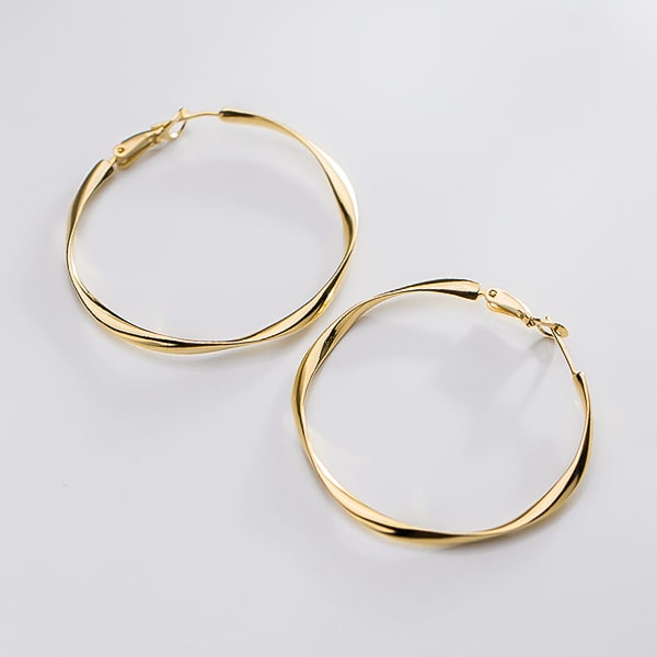 Large irregular gold hoop earrings detail