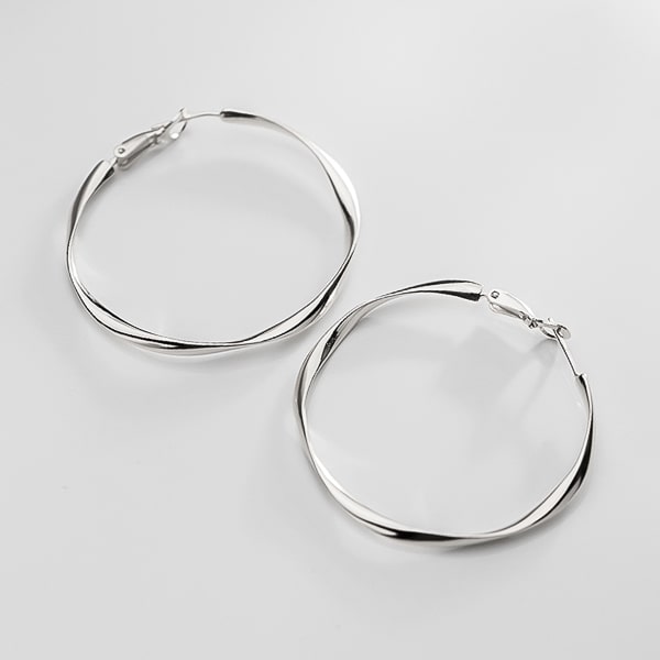 Large irregular silver hoop earrings detail