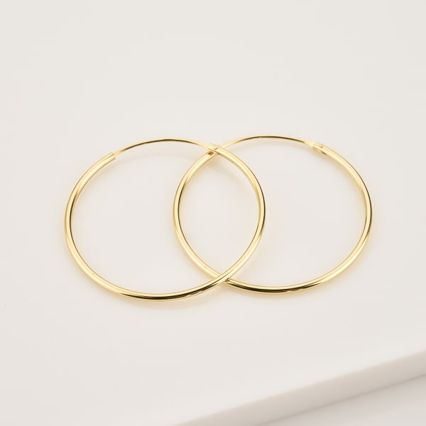 Large thin gold hoop earrings details