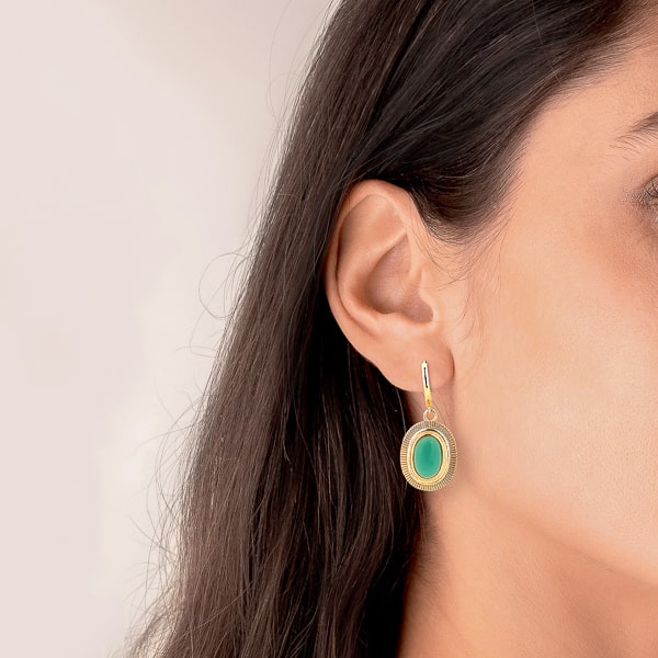 Woman wearing large turquoise oval stone drop earrings