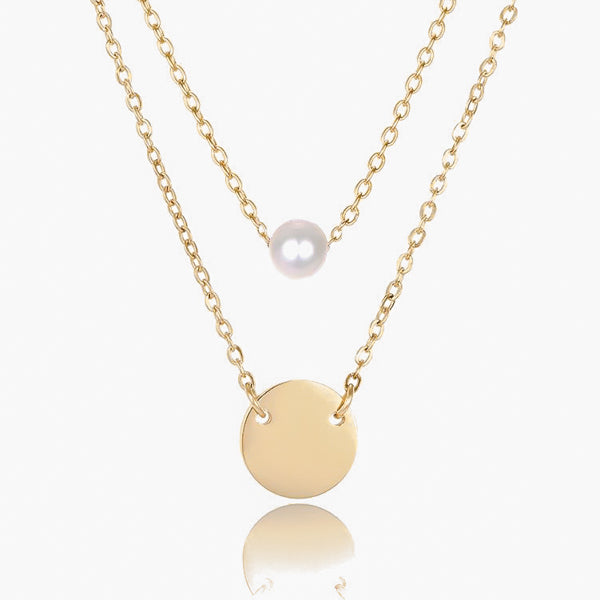 Pearl and coin charm on layered gold necklace chains