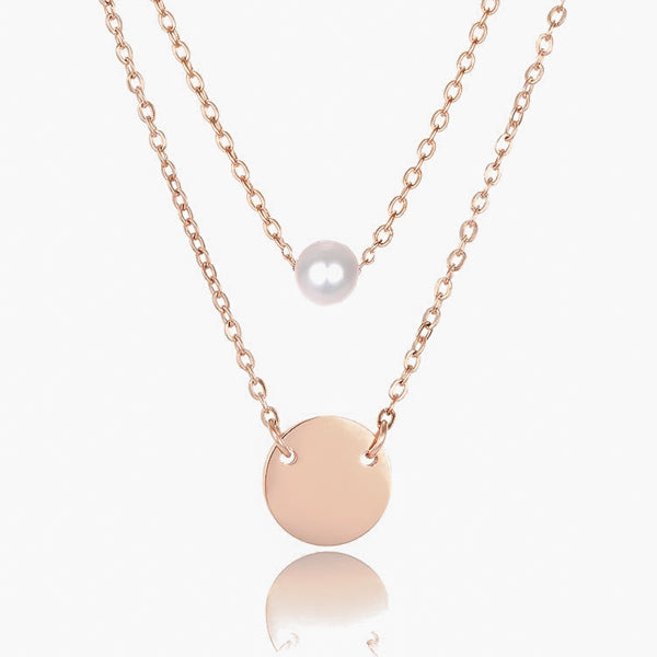 Pearl and coin charm on layered rose gold necklace chains