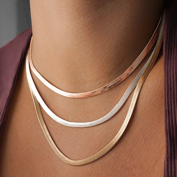 Woman wearing a layered snake chain necklace