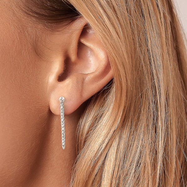 Woman wearing long silver crystal drop bar earrings