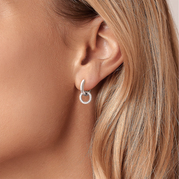 Woman wearing silver cubic zirconia circle hoop earrings