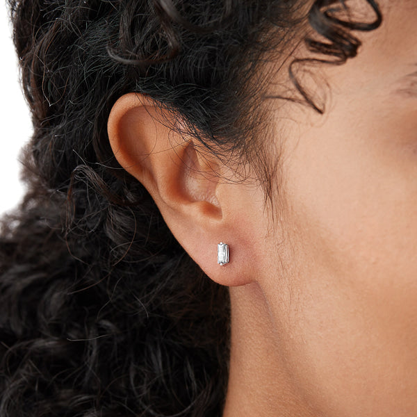 Woman wearing silver mini baguette cubic zirconia stud earrings