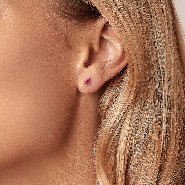 Woman wearing gold pink teardrop cubic zirconia mini stud earrings