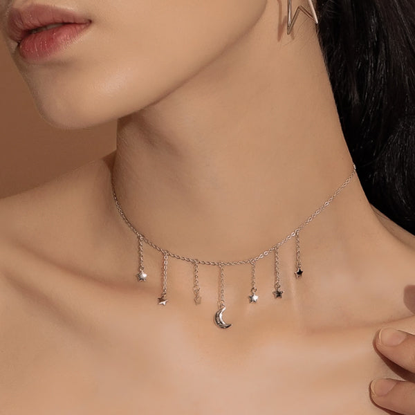 Woman wearing a silver moon & stars drop choker necklace