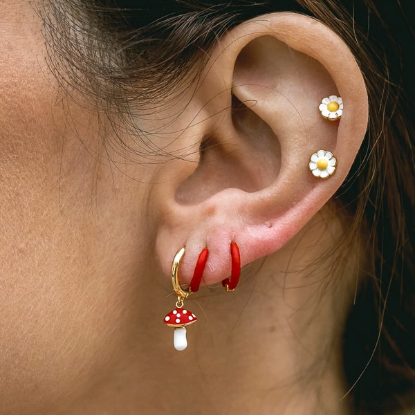 Woman wearing mushroom mini hoop drop earrings