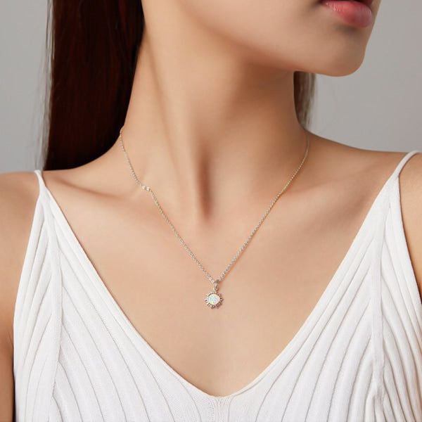 Woman wearing a silver opal sun pendant necklace
