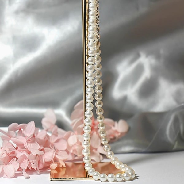 5mm pearl necklace hanging from a display rack