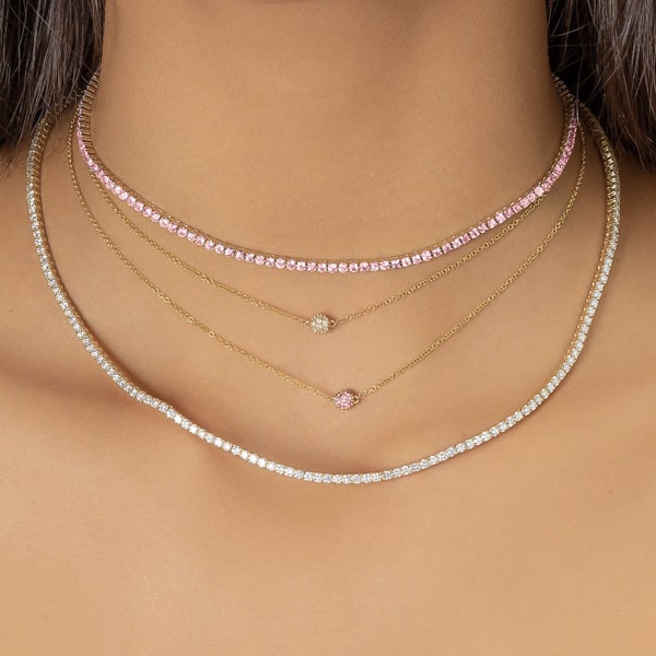 Woman wearing a pink and gold tennis choker necklace