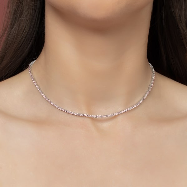 Woman wearing a pink and silver tennis choker necklace