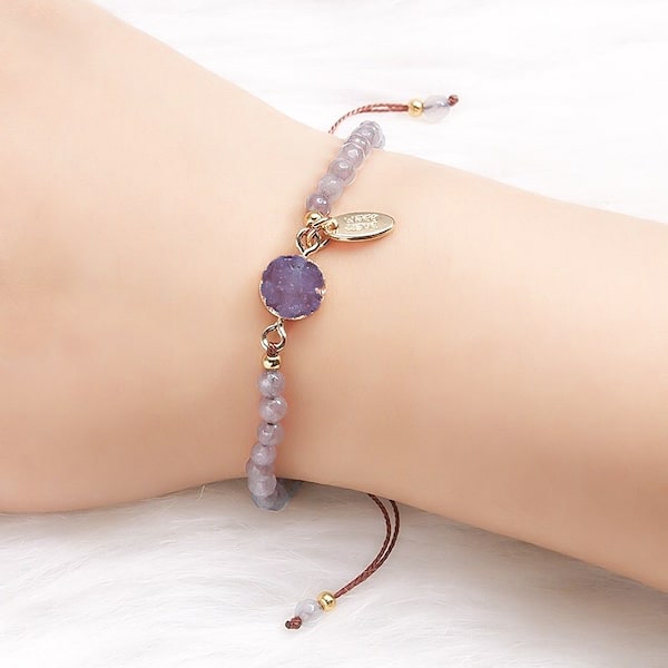 Woman wearing a purple beaded amethyst geode bracelet