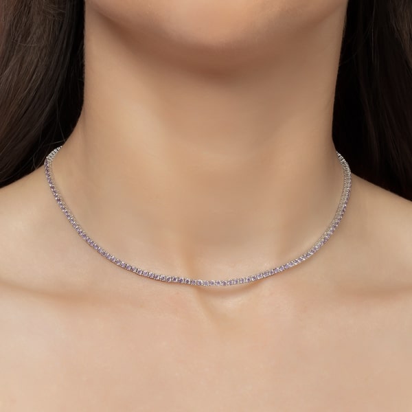 Woman wearing a purple and silver tennis choker necklace