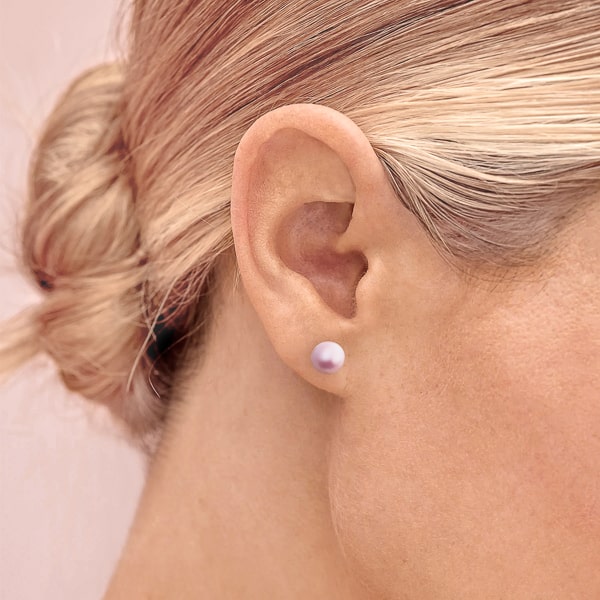 Purple pearl stud earrings on model