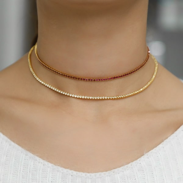 Woman wearing a red and gold tennis choker necklace