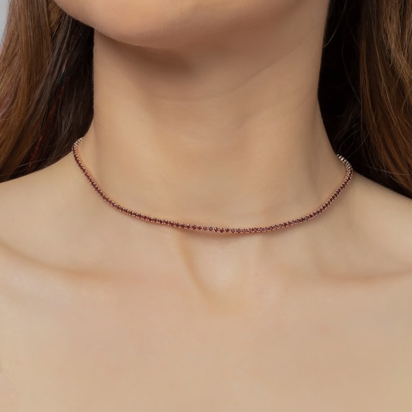 Woman wearing a red and silver tennis choker necklace