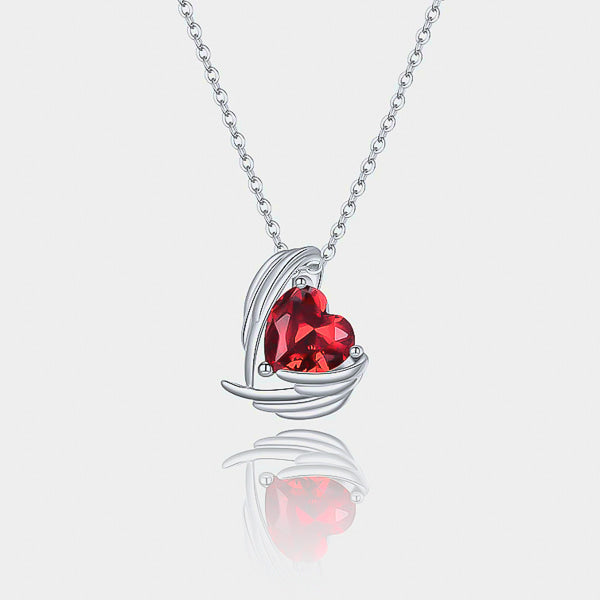 Garnet red crystal heart & angel wings pendant hanging from a silver necklace details