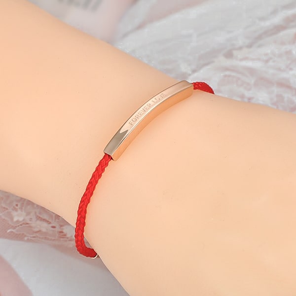 Red rope love bar bracelet on woman's wrist