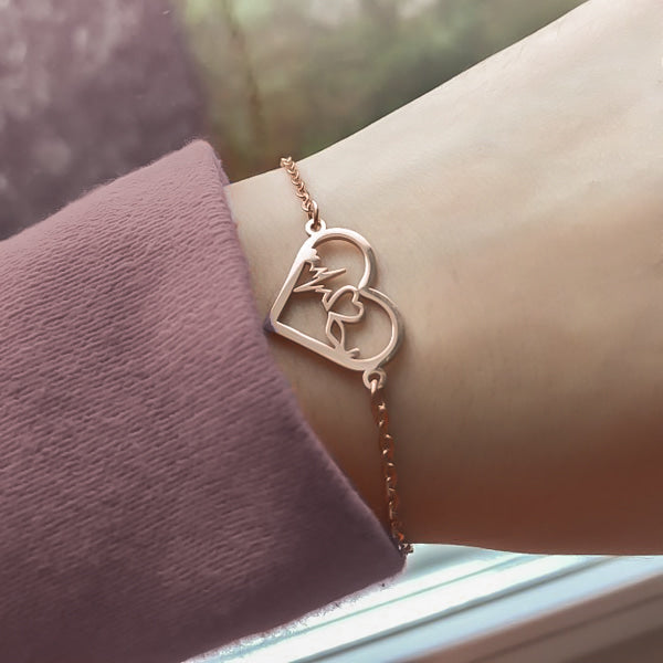 Woman wearing a rose gold heartbeat bracelet on her wrist
