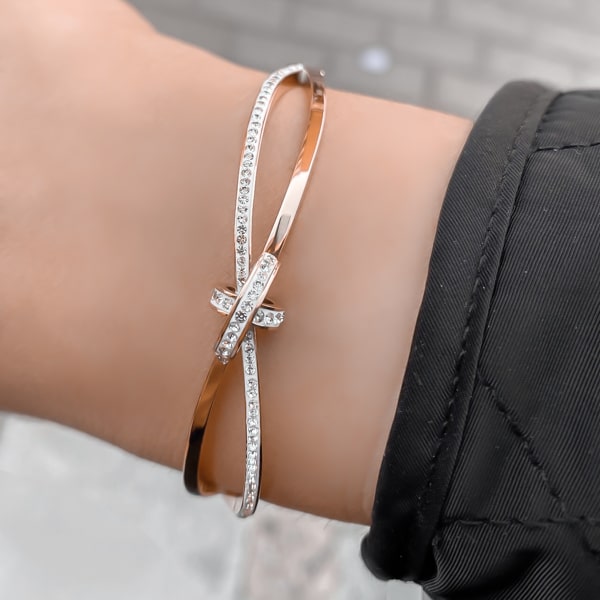 Woman wearing a rose gold crystal knot bracelet