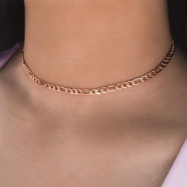 Woman wearing a rose gold figaro choker necklace
