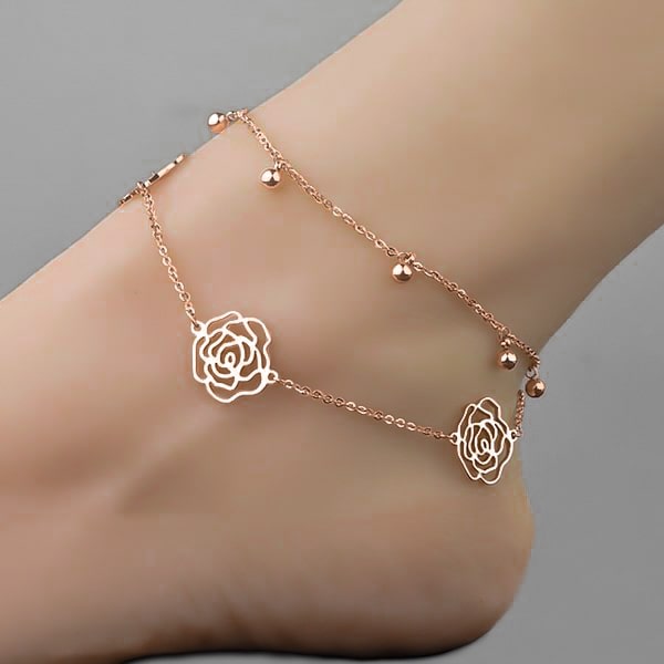 Woman wearing a rose gold rose flower anklet