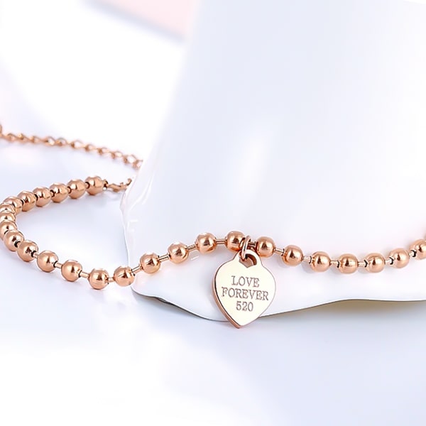 Rose gold beaded heart charm ankle bracelet detailed close-up