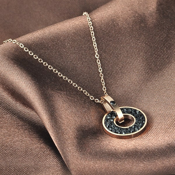 Black crystal ring pendant on a rose gold necklace display