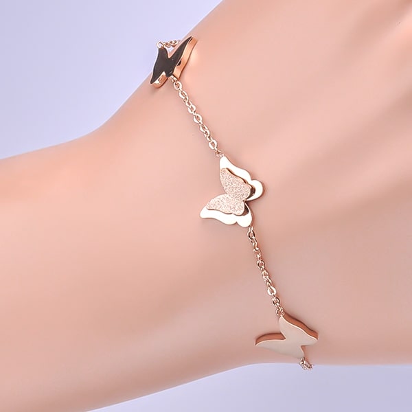 Rose gold butterfly bracelet displayed on a woman's wrist